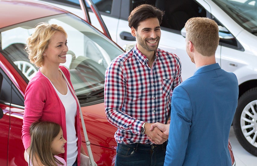 Kemna customer standing in front of the dealership